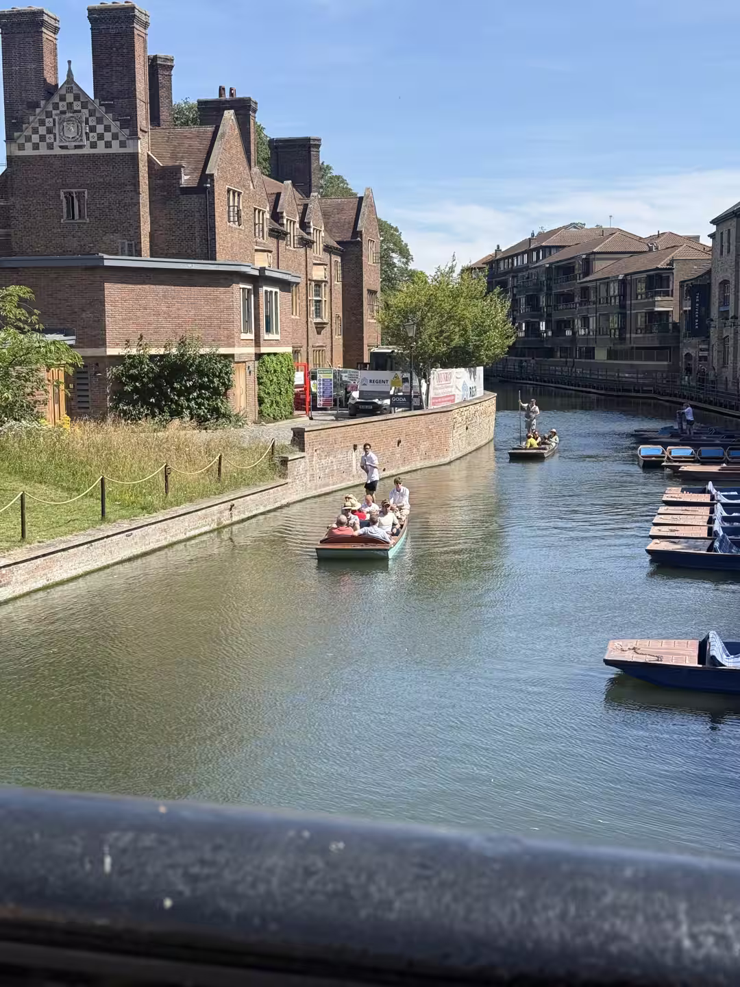 The River Cam with punts and colleges near a punting station, Cambridge