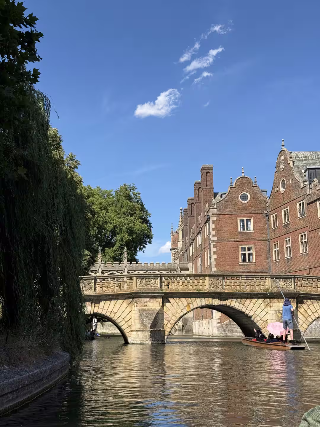 A red-brick Cambridge college and bridge over the River Cam